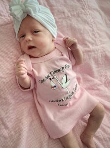 A newborn baby wearing pink