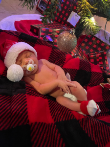 A newborn baby wearing a santa hat