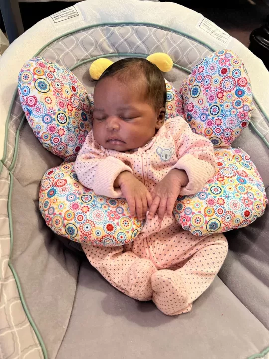 A baby wearing a pink outfit