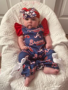 A baby wearing a Braves outfit