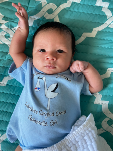 A baby wearing a blue shirt