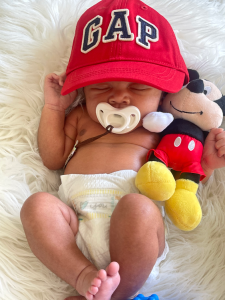 A baby wearing a GAP hat